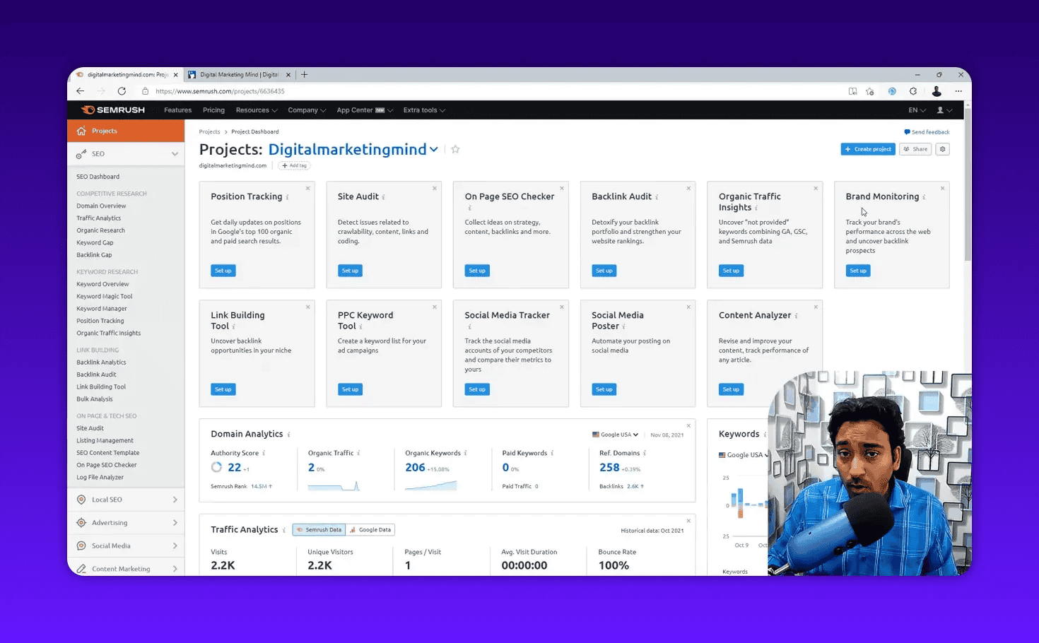 Clear Semrush Projects dashboard screenshot showing setup tiles for Position Tracking, Site Audit, On Page SEO Checker, Backlink Audit and a Domain Analytics summary with a small presenter overlay.